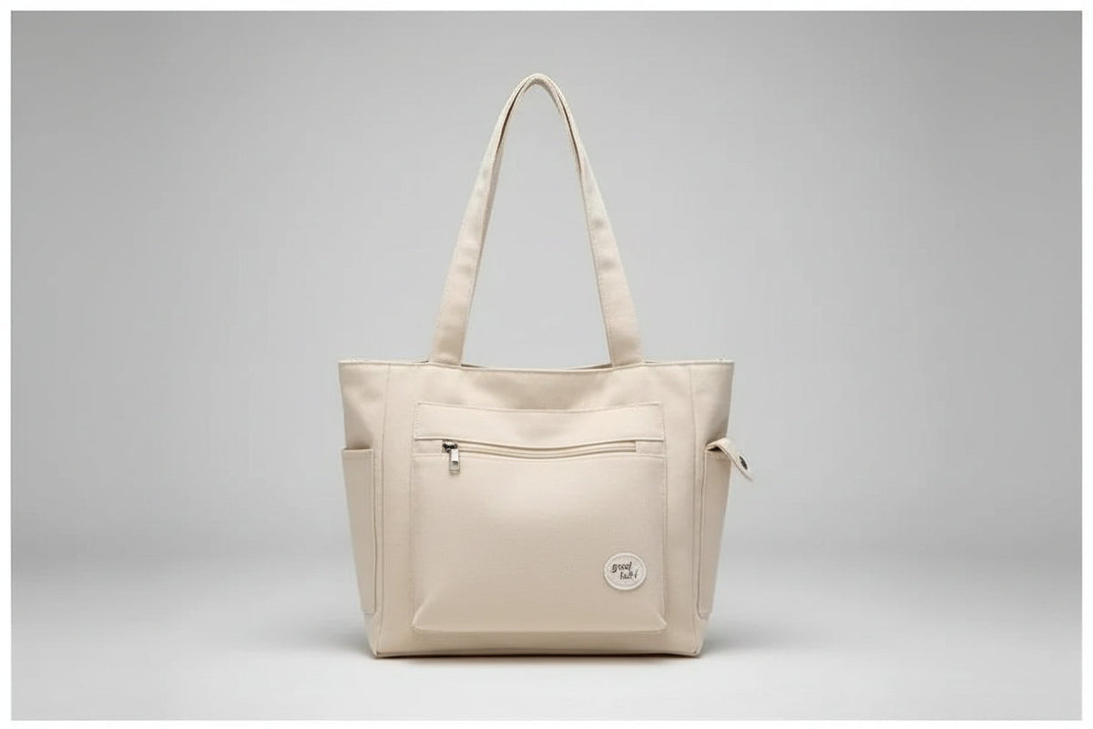 Beige tote bag on denim jacket with phone and clear glass bottle
