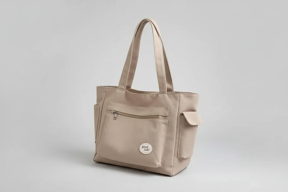 Beige handbag on a denim jacket with a white background